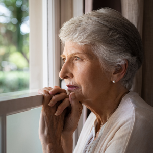 Elderly woman looking out a window