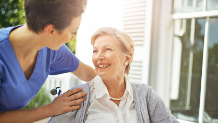 a nurse helping an older lady