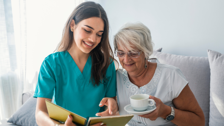 senior reading with caregiver