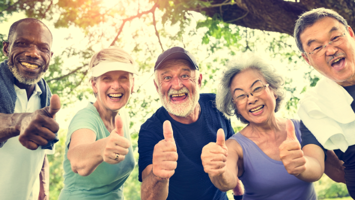 a group senior people giving a thumbs-up
