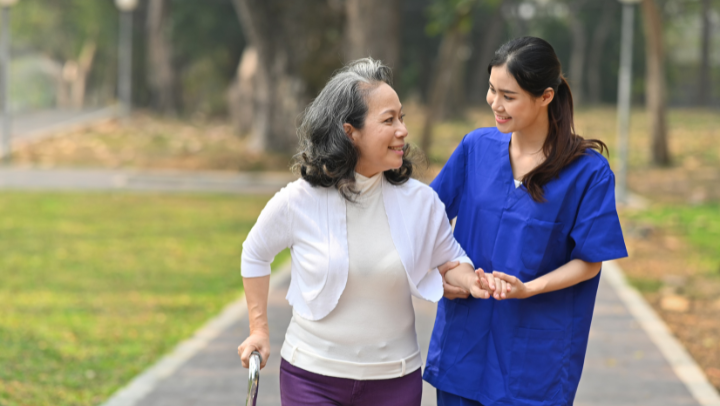 caregiver helping old lady