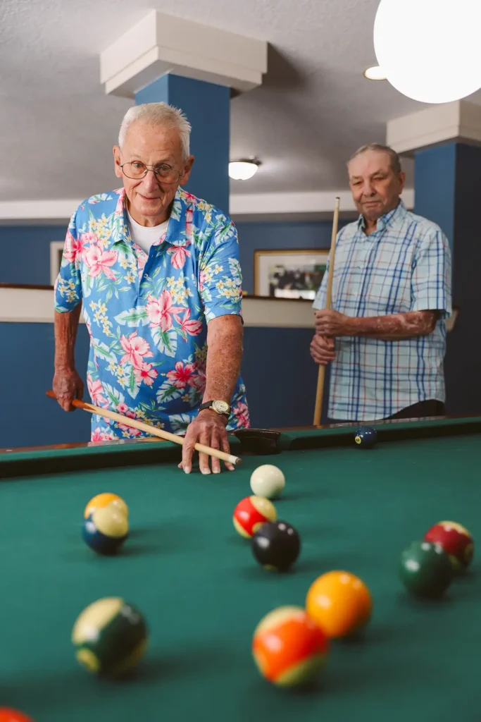 Senior men playing pool at Addington Place of East Lake