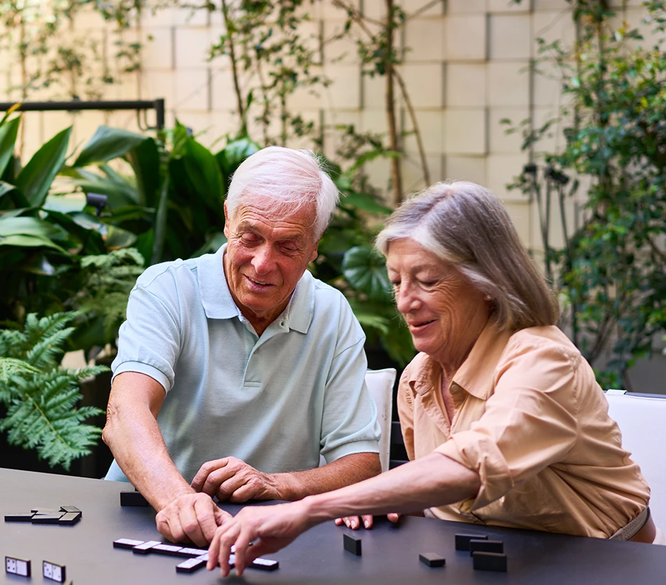 couple of senior playing boardgames