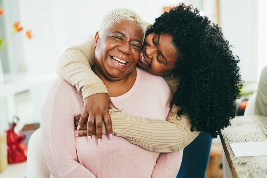 Adult daughter hugging mom