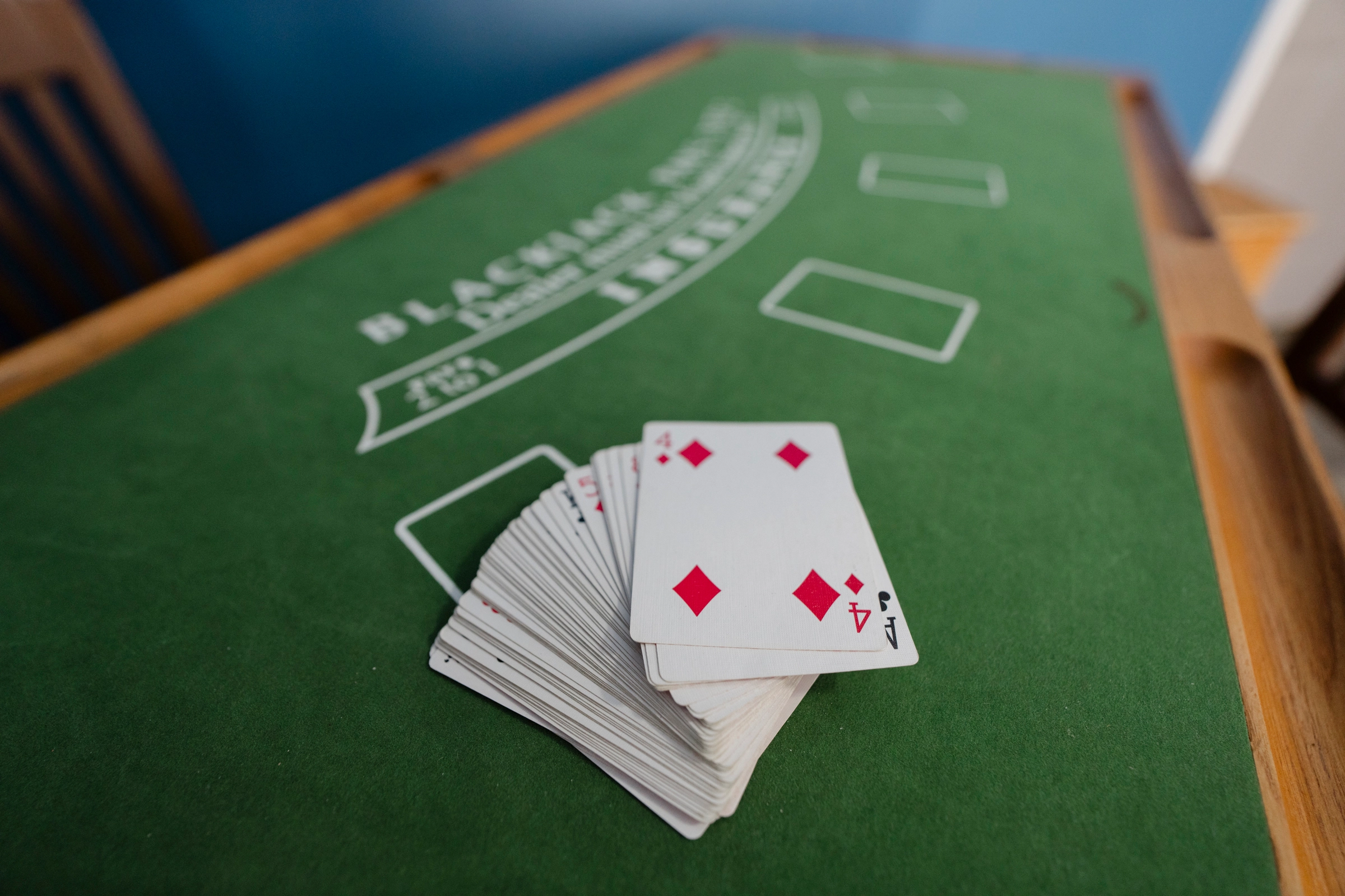 Game room featuring blackjack table and cards